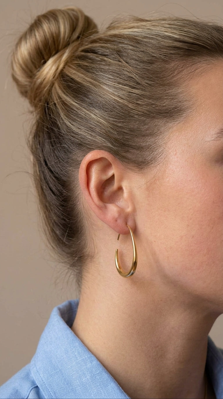 Woman wearing Maia gold hoop earrings