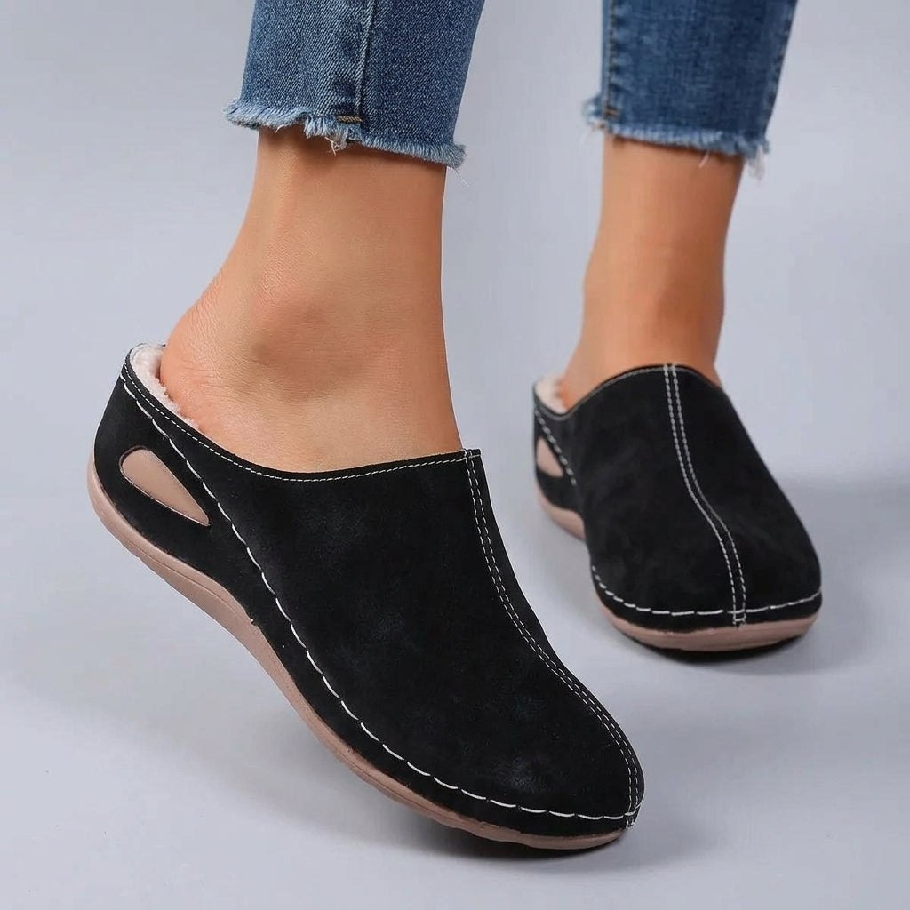 Woman wearing Rosie slippers in black