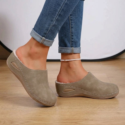 Woman wearing Rosie slippers in brown with jeans
